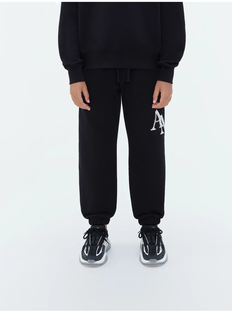 Amiri KIDS - AMIRI STAGGERED SCRIBBLE SWEATPANT - Black