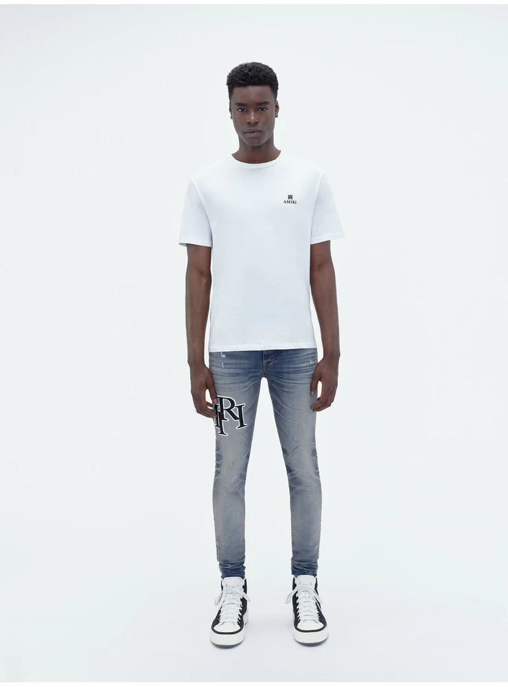 Amiri STAGGERED EMBROIDERED LOGO JEAN - Antique Indigo